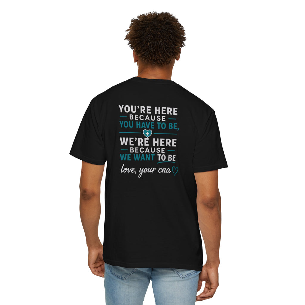 CNA T-Shirt — "We're Here Because We Want To Be" Heartfelt CNA Gift | Unisex Heavyweight Garment-Dyed Tee