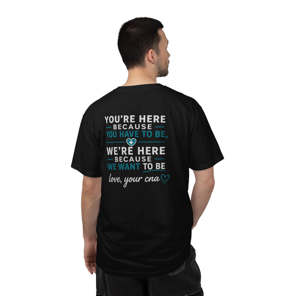 CNA T-Shirt — "We're Here Because We Want To Be" Heartfelt CNA Gift | Unisex Heavyweight Garment-Dyed Tee